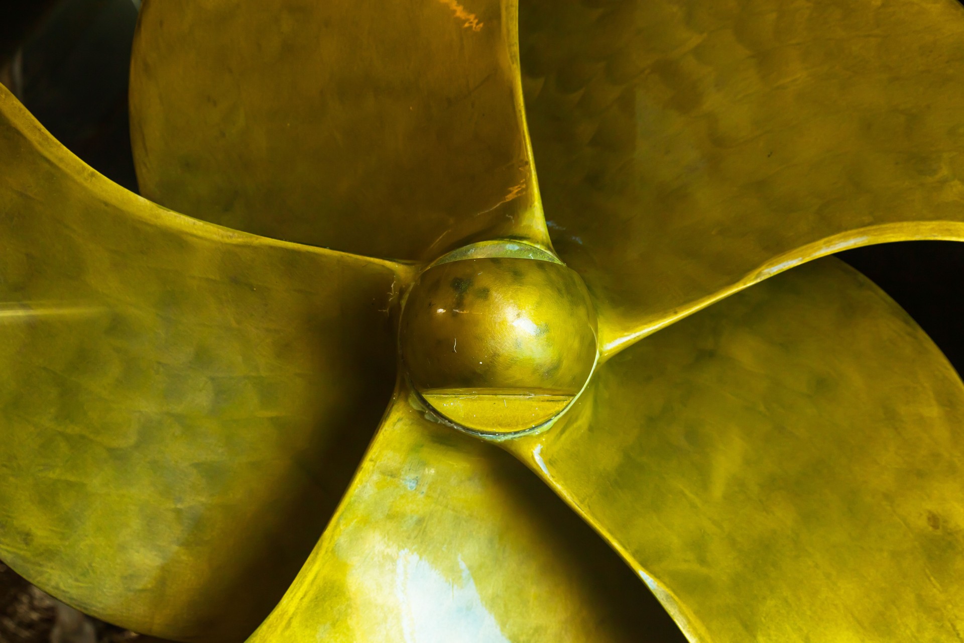 A new bronze five-bladed propeller is installed on the ship, close-up.